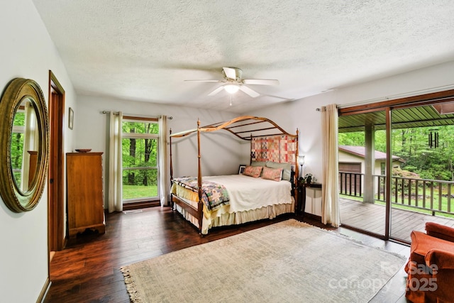 675 Terrys Gap Rd, Hendersonville, NC 28792 - bedroom with access to outside, hardwood / wood-style flooring, a textured ceiling, a ceiling fan, and baseboards
