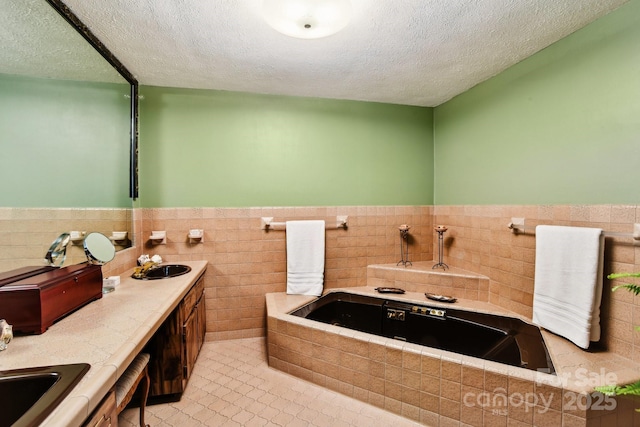 675 Terrys Gap Rd, Hendersonville, NC 28792 - bathroom with a textured ceiling, tile walls, a garden tub, a wainscoted wall, and double vanity