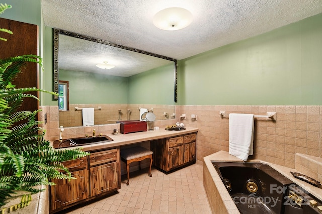 675 Terrys Gap Rd, Hendersonville, NC 28792 - bathroom with tile walls, a textured ceiling, a jetted tub, double vanity, and wainscoting