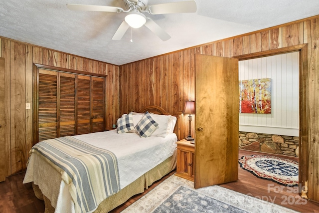 675 Terrys Gap Rd, Hendersonville, NC 28792 - bedroom with wooden walls, a closet, and a ceiling fan