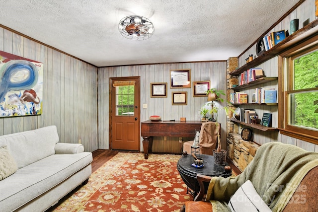 675 Terrys Gap Rd, Hendersonville, NC 28792 - living room featuring wood finished floors, a textured ceiling, wood walls, and crown molding
