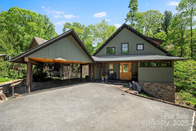 view of front of home with covered porch, board and batten siding, and aphalt driveway
