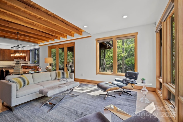 living room with recessed lighting, baseboards, a wealth of natural light, and light wood-style flooring
