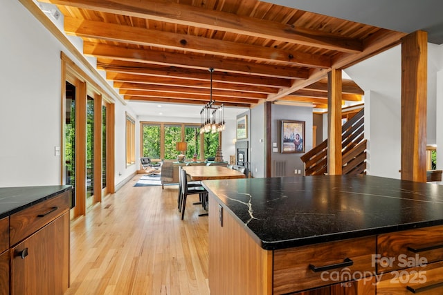 kitchen featuring wooden ceiling, light wood-type flooring, and beam ceiling