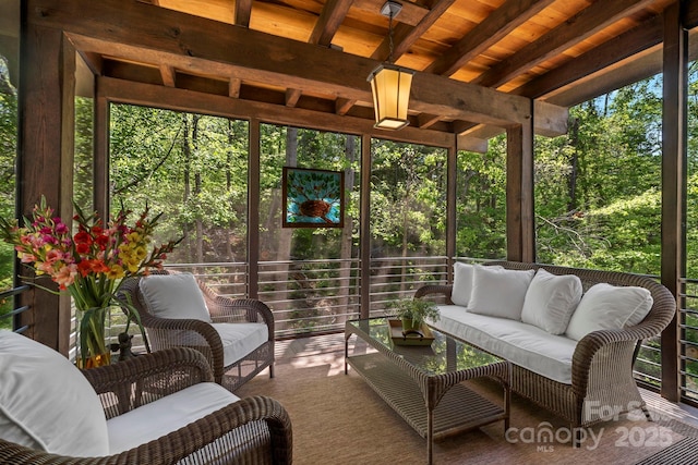 sunroom / solarium featuring outdoor lounge area and beam ceiling