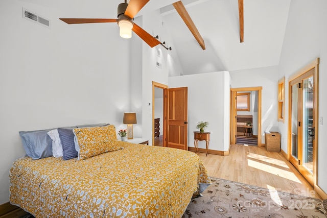 bedroom featuring a ceiling fan, visible vents, wood finished floors, high vaulted ceiling, and beamed ceiling