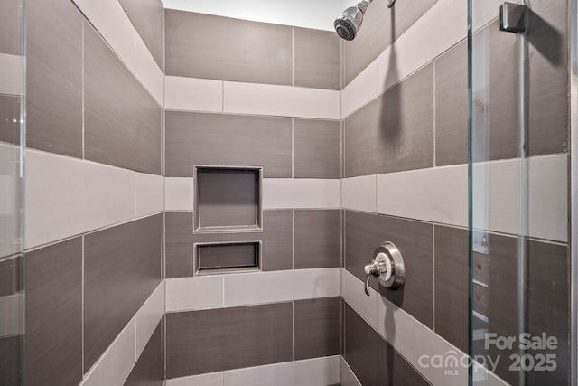 full bath with a tile shower