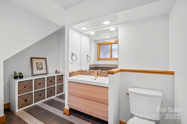 bathroom with vanity, toilet, tile patterned floors, recessed lighting, and baseboards