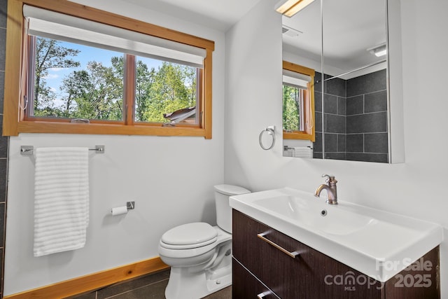 bathroom featuring vanity, baseboards, and toilet