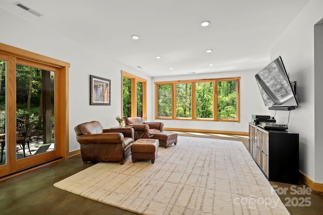 living room with baseboards, concrete floors, recessed lighting, and visible vents