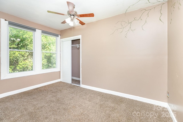 unfurnished bedroom with baseboards, a closet, ceiling fan, and carpet