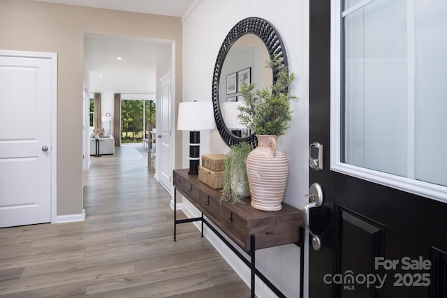 entryway featuring baseboards, recessed lighting, and light wood-style flooring
