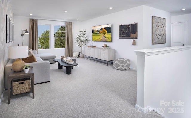 carpeted living area featuring baseboards and recessed lighting