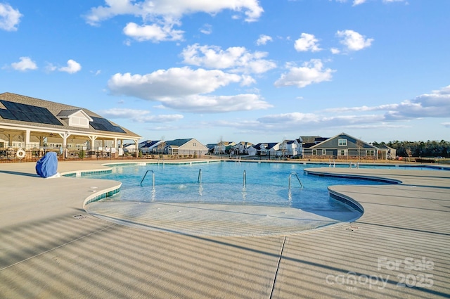 pool featuring a patio area and fence