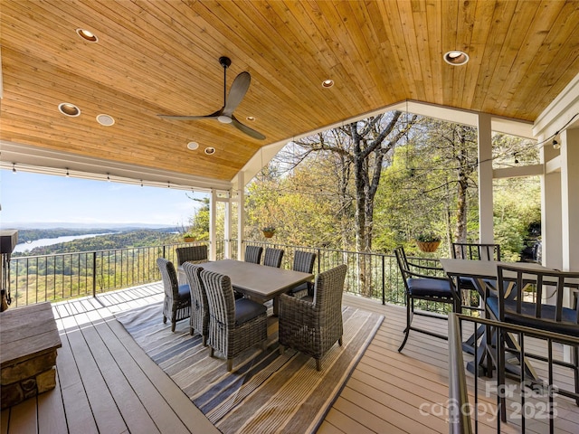 wooden terrace featuring a ceiling fan and outdoor dining space