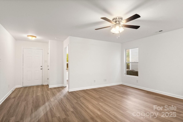 7616 Monarch Birch Ln, Charlotte, NC 28215 - unfurnished room with a ceiling fan, baseboards, and wood finished floors