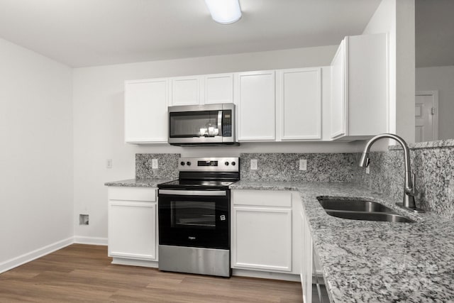 7616 Monarch Birch Ln, Charlotte, NC 28215 - kitchen featuring baseboards, a sink, white cabinets, and stainless steel appliances