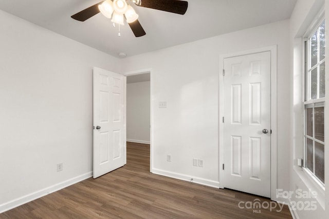 7616 Monarch Birch Ln, Charlotte, NC 28215 - unfurnished bedroom featuring baseboards, ceiling fan, and wood finished floors