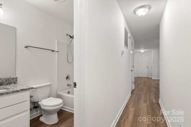 7616 Monarch Birch Ln, Charlotte, NC 28215 - full bath with vanity, shower / bathtub combination, wood finished floors, toilet, and baseboards