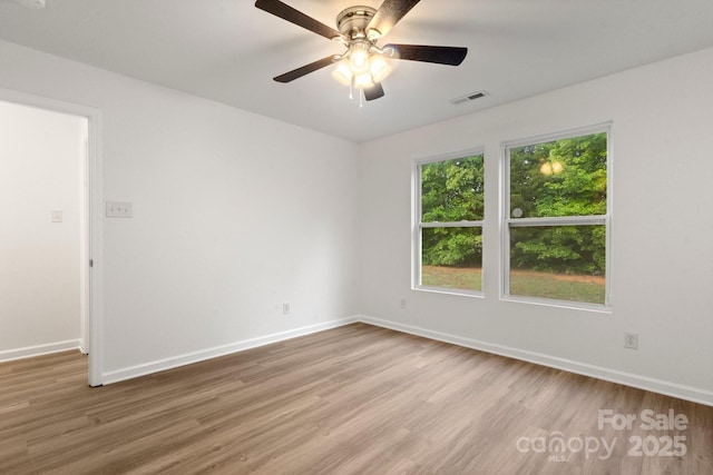 7616 Monarch Birch Ln, Charlotte, NC 28215 - unfurnished room featuring baseboards, ceiling fan, wood finished floors, and visible vents