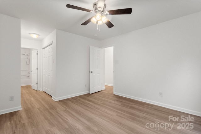 7616 Monarch Birch Ln, Charlotte, NC 28215 - unfurnished bedroom with connected bathroom, ceiling fan, light wood-style flooring, baseboards, and a closet