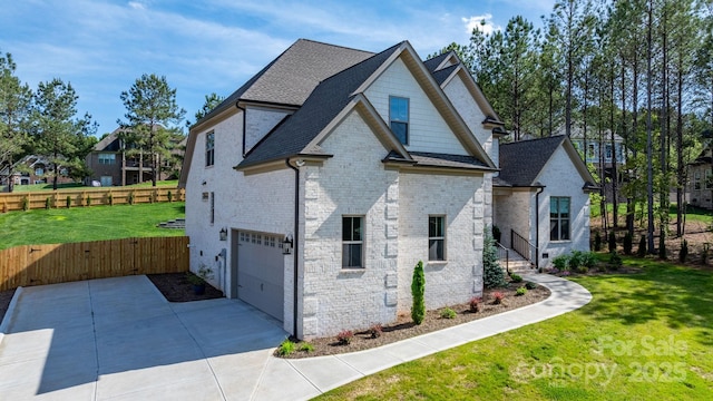 view of property exterior with an attached garage, roof with shingles, driveway, and a gate