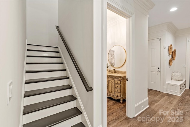 stairway featuring baseboards, recessed lighting, and wood finished floors