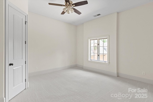 empty room with ceiling fan, light carpet, baseboards, and visible vents