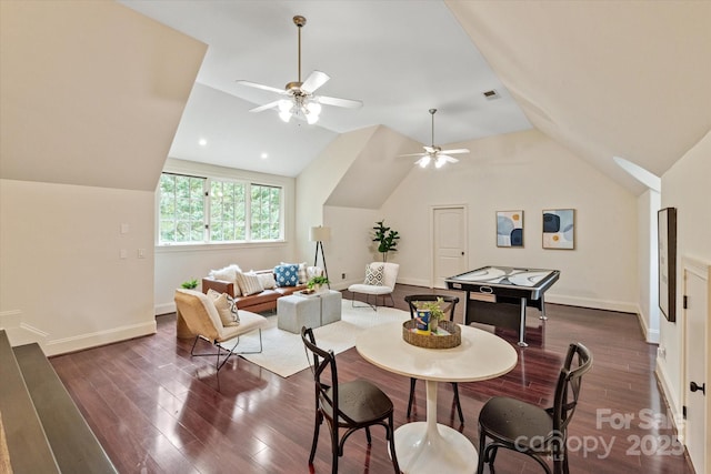 dining space with vaulted ceiling, dark wood-type flooring, and a ceiling fan