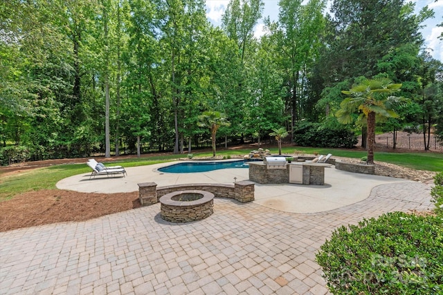 pool with a fire pit and a patio