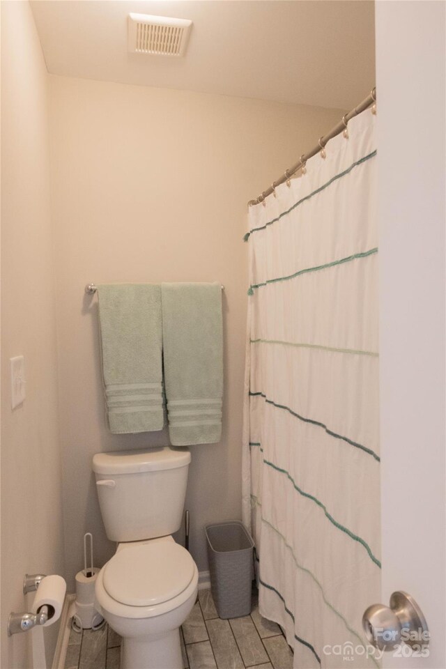 217 Hydrangea Dr, Clover, SC 29710 - full bath featuring visible vents, tile patterned flooring, toilet, baseboards, and a shower with curtain