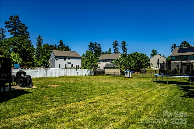 217 Hydrangea Dr, Clover, SC 29710 - view of yard with a fenced backyard, a trampoline, and a residential view