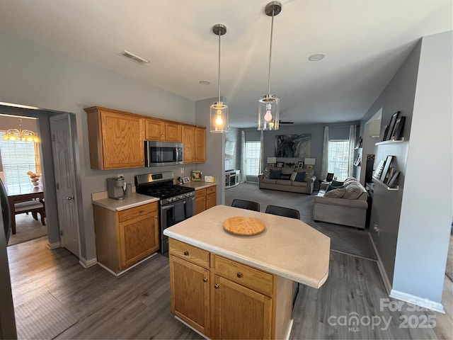 12244 Wallace Ridge Dr, Charlotte, NC 28269 - kitchen with light countertops, appliances with stainless steel finishes, dark wood-type flooring, and visible vents