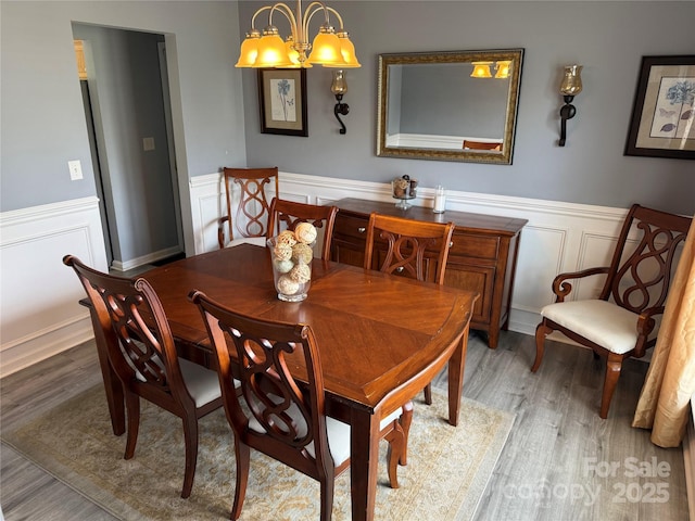 12244 Wallace Ridge Dr, Charlotte, NC 28269 - dining room featuring a wainscoted wall, wood finished floors, and a decorative wall