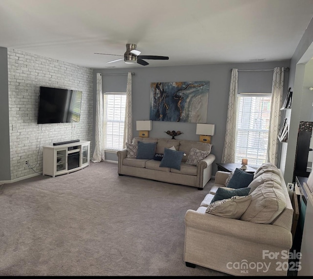 12244 Wallace Ridge Dr, Charlotte, NC 28269 - carpeted living area featuring a ceiling fan, brick wall, and plenty of natural light