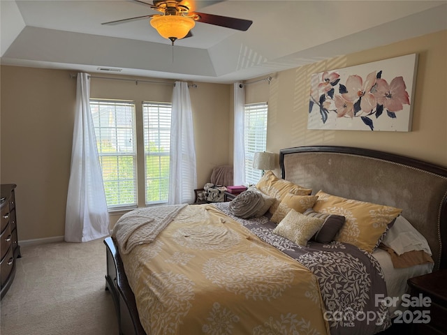 12244 Wallace Ridge Dr, Charlotte, NC 28269 - bedroom with visible vents, a ceiling fan, multiple windows, and light carpet