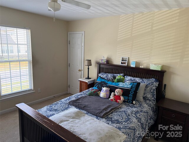 12244 Wallace Ridge Dr, Charlotte, NC 28269 - carpeted bedroom featuring baseboards, ceiling fan, and multiple windows