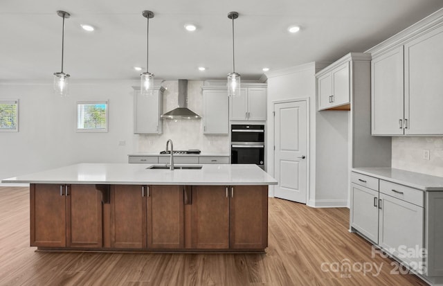 2008 Waxhaw Crossing Dr, Waxhaw, NC 28173 - kitchen with a sink, light wood-style floors, light countertops, double oven, and wall chimney exhaust hood