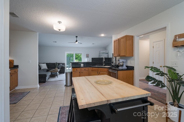 744 Chipmeadow Ln, York, SC 29745 - kitchen featuring stainless steel dishwasher, a peninsula, a sink, ceiling fan, and light tile patterned floors