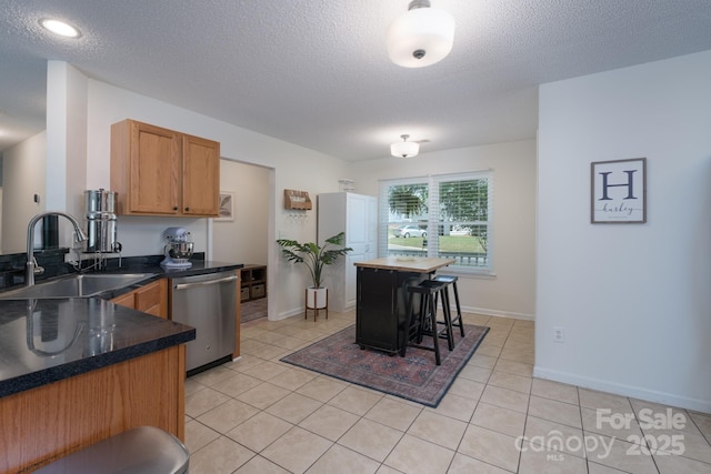 744 Chipmeadow Ln, York, SC 29745 - kitchen featuring dishwasher, a sink, dark countertops, a textured ceiling, and light tile patterned floors