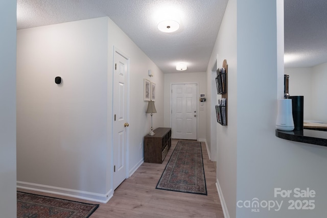 744 Chipmeadow Ln, York, SC 29745 - hall featuring a textured ceiling, light wood-style flooring, and baseboards