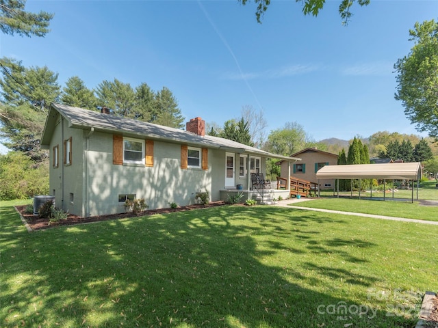 ranch-style house with cooling unit, a chimney, a front yard, and a carport