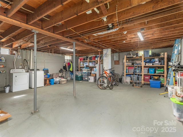 unfinished basement with independent washer and dryer and gas water heater