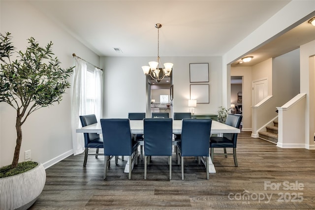 dining area with visible vents, dark wood finished floors, stairway, baseboards, and a notable chandelier
