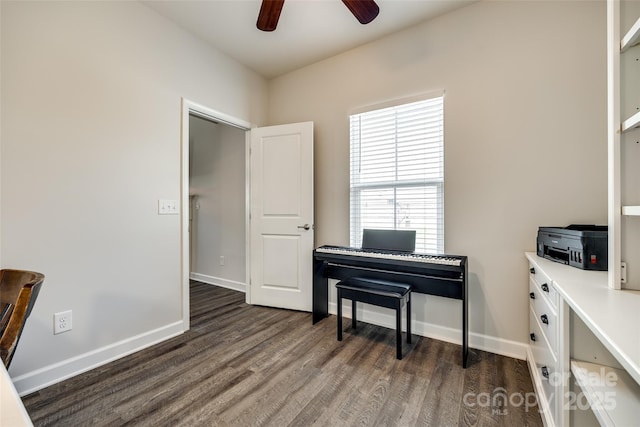 living area featuring baseboards, dark wood finished floors, and ceiling fan