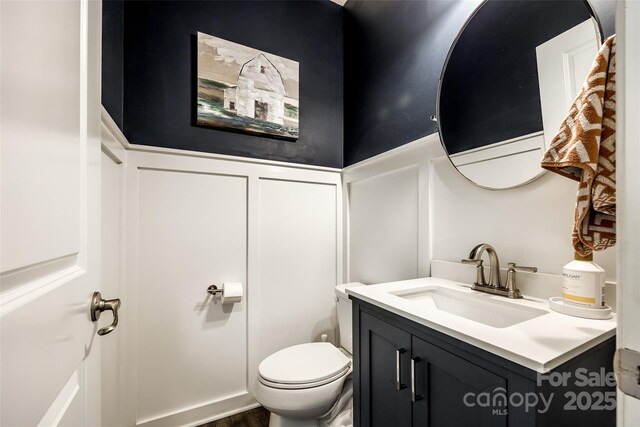 bathroom featuring vanity and toilet