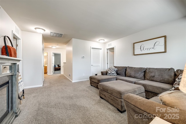 living area featuring baseboards, visible vents, and carpet
