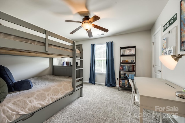 carpeted bedroom featuring baseboards, ceiling fan, and visible vents
