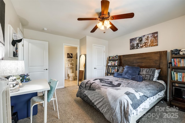 carpeted bedroom with baseboards, a ceiling fan, and ensuite bath