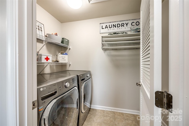 clothes washing area featuring laundry area, washer and clothes dryer, baseboards, and light tile patterned floors